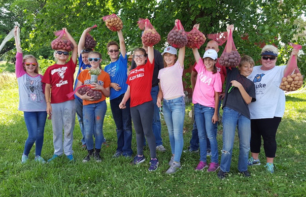 volunteers with freshly picked produce